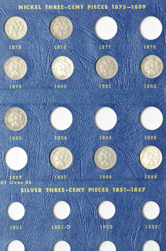 Collection of two-cent pieces and three-cent nickels in a Whitman 9436 album