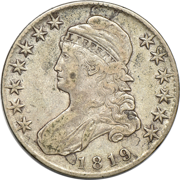 A Flowing Hair half-dollar, plus three Capped Bust half-dollars