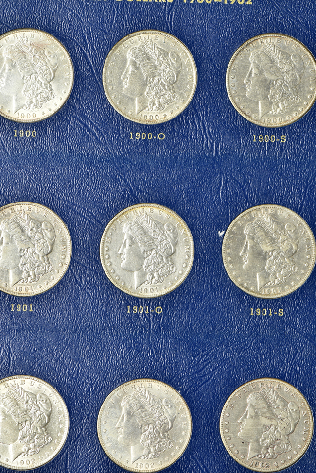 Collection of twenty-seven Morgan silver dollars, 1897 through 1921-S, in a Whitman 9429 album