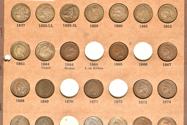 Three Flying Eagle cents and forty-eight Indian Head cents in a Wayte Raymond album