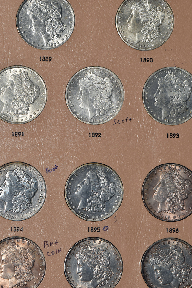 Collection of Morgan, Peace, Eisenhower, and Susan B. Anthony dollars in a Dansco album