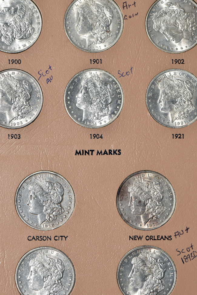 Collection of Morgan, Peace, Eisenhower, and Susan B. Anthony dollars in a Dansco album