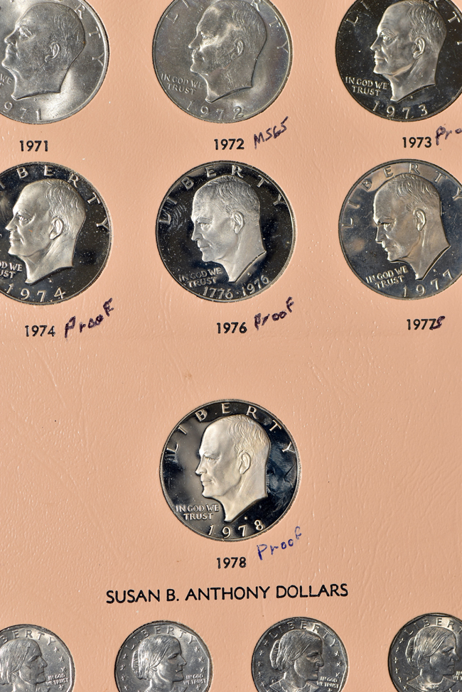 Collection of Morgan, Peace, Eisenhower, and Susan B. Anthony dollars in a Dansco album