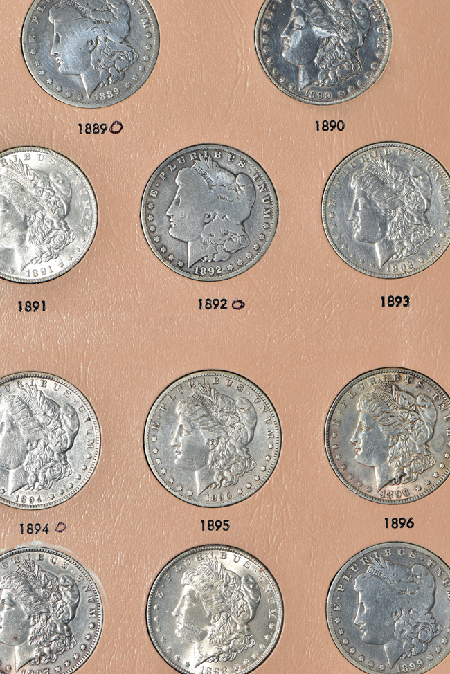 Collection of Morgan, Peace, Eisenhower, and Susan B. Anthony dollars in a Dansco album