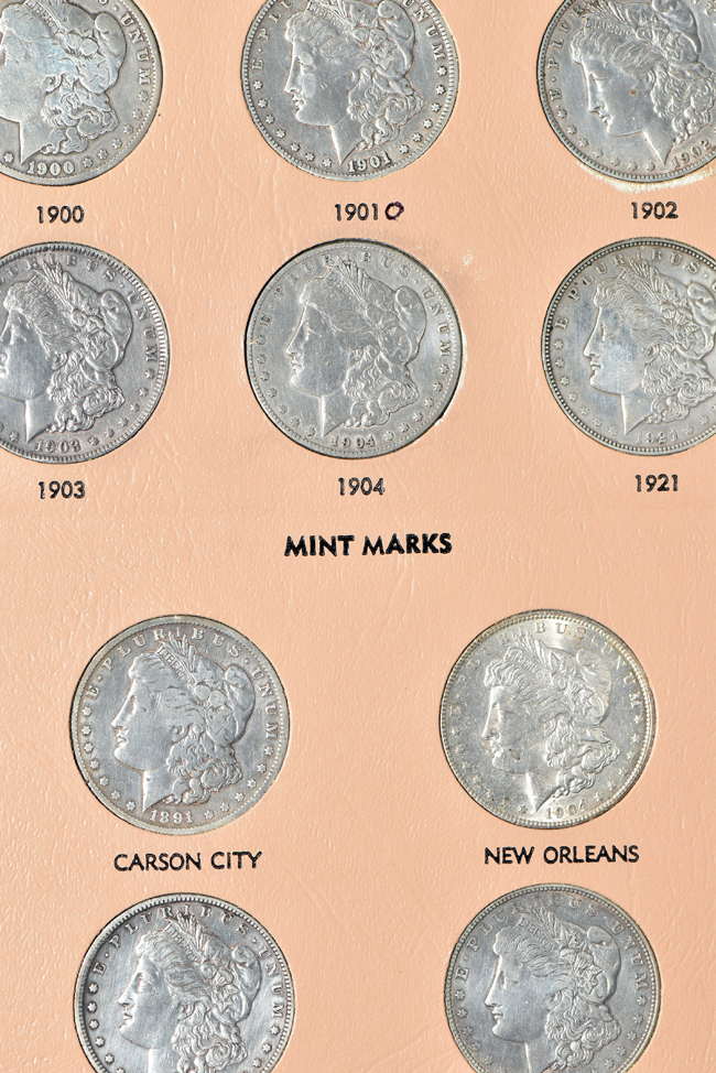 Collection of Morgan, Peace, Eisenhower, and Susan B. Anthony dollars in a Dansco album
