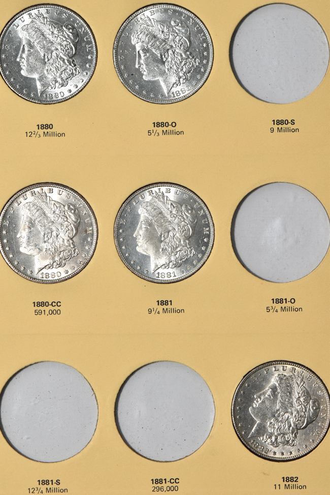 Twenty-two different Morgan silver dollars in a Library of Coins Vol. 23 album