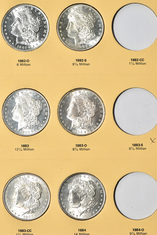 Twenty-two different Morgan silver dollars in a Library of Coins Vol. 23 album