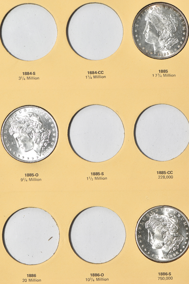 Twenty-two different Morgan silver dollars in a Library of Coins Vol. 23 album