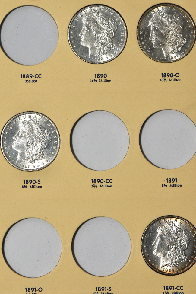 Seventeen different Morgan silver dollars in a Library of Coins Vol. 24 album