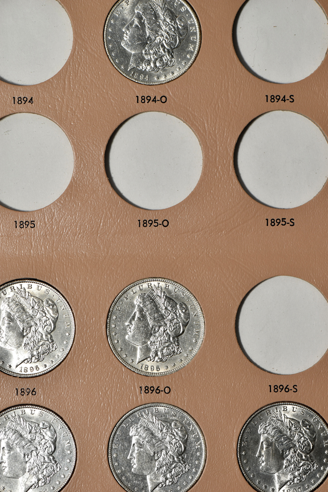 Collection of thirty-three different Morgan silver dollars in a Dansco 7179 album
