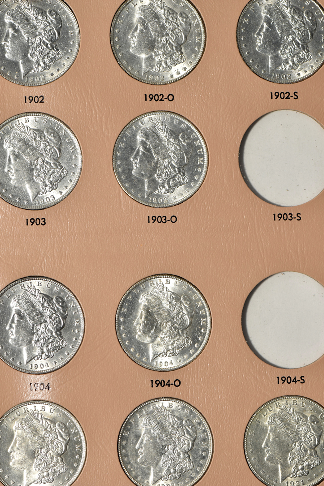 Collection of thirty-three different Morgan silver dollars in a Dansco 7179 album