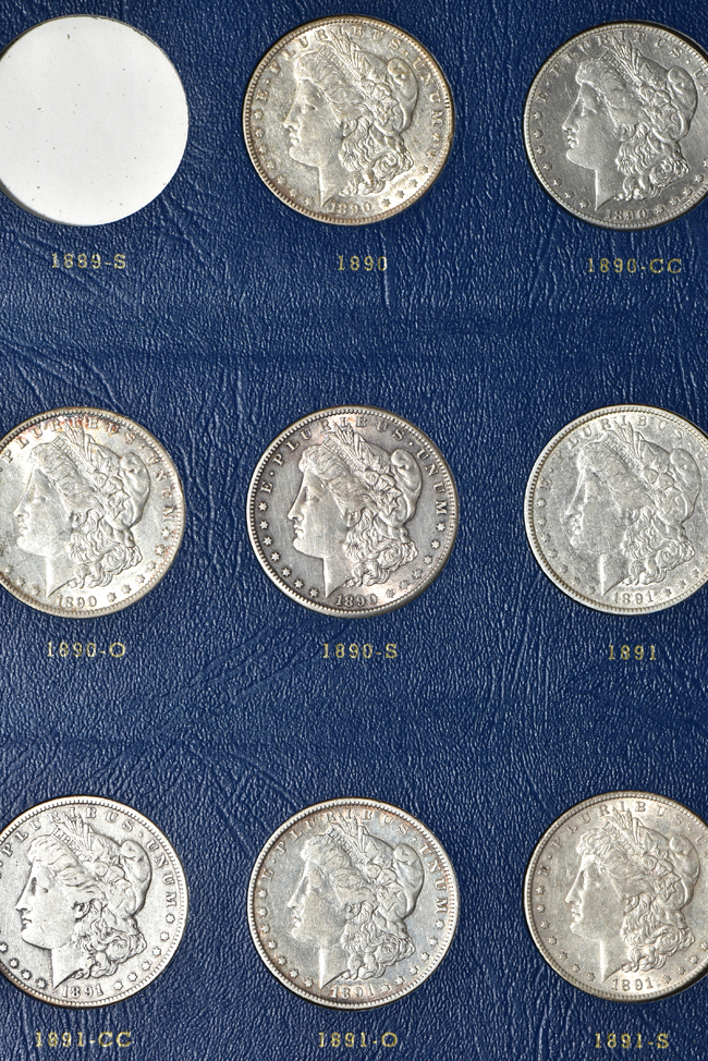 Collection of seventy-two different Morgan silver dollars in three Whitman albums