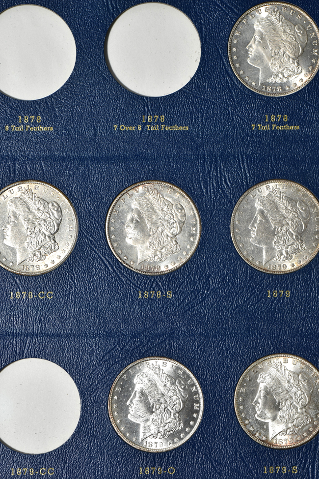 Collection of seventy-two different Morgan silver dollars in three Whitman albums