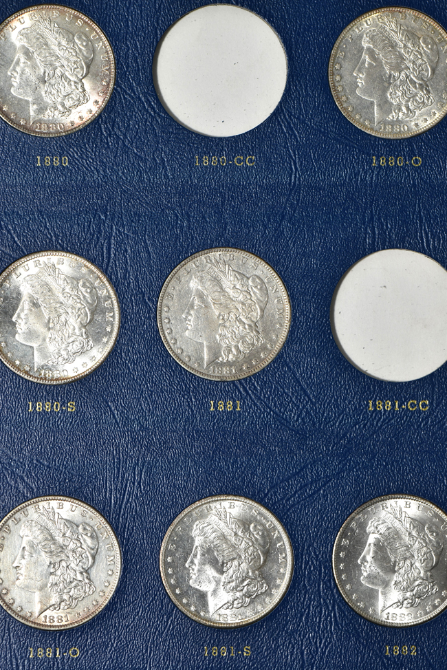 Collection of seventy-two different Morgan silver dollars in three Whitman albums