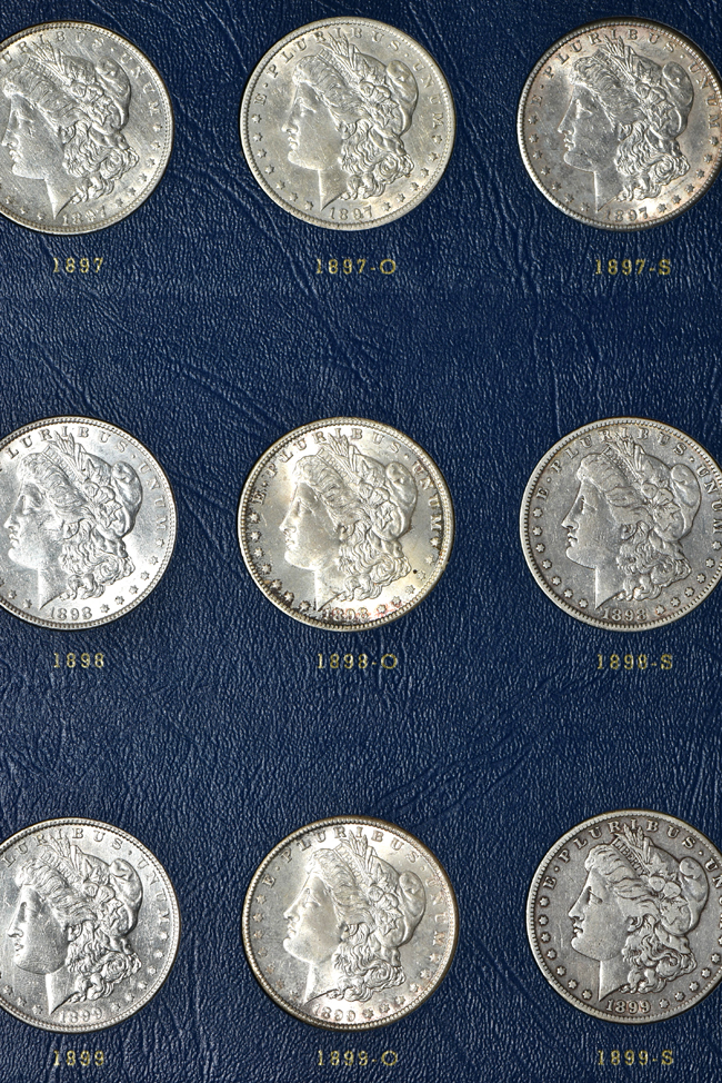 Collection of seventy-two different Morgan silver dollars in three Whitman albums