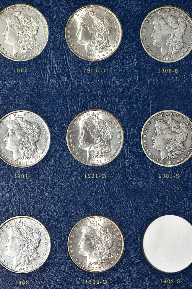 Collection of seventy-two different Morgan silver dollars in three Whitman albums
