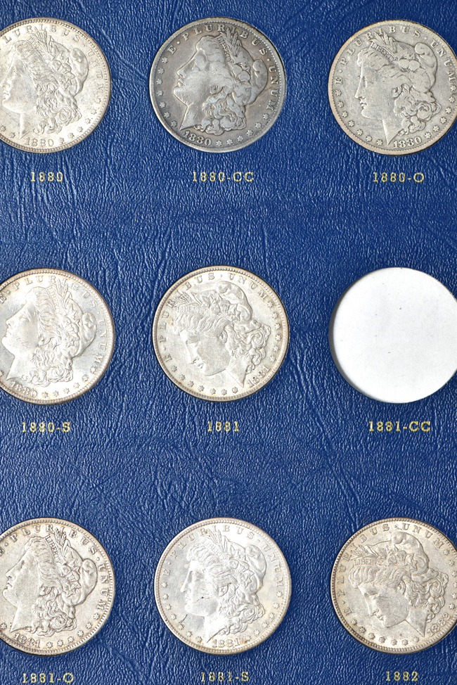 Group of fifty-seven different Morgan silver dollars in two Whitman albums