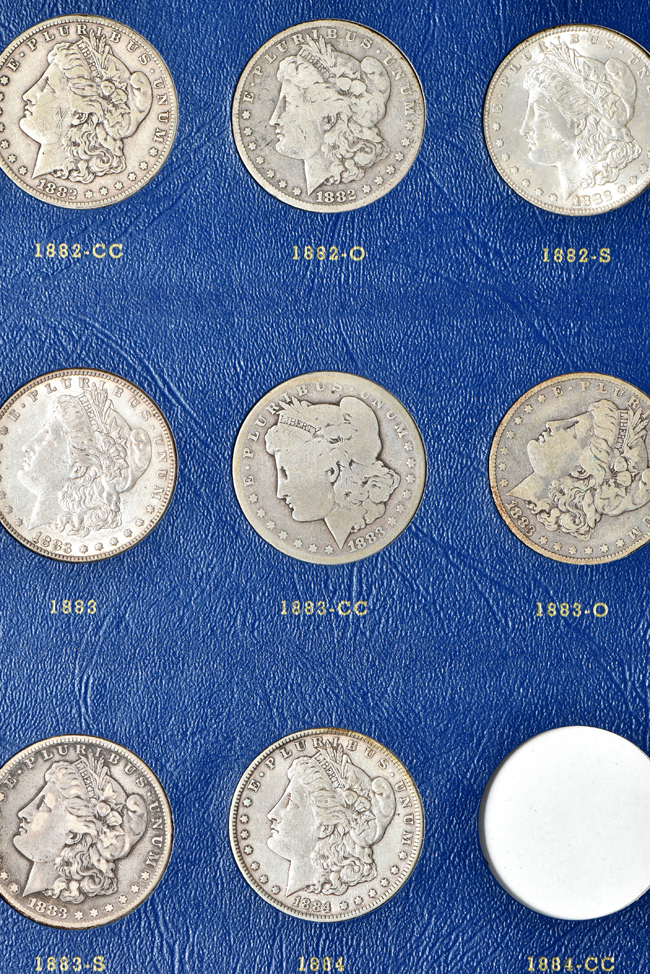 Group of fifty-seven different Morgan silver dollars in two Whitman albums