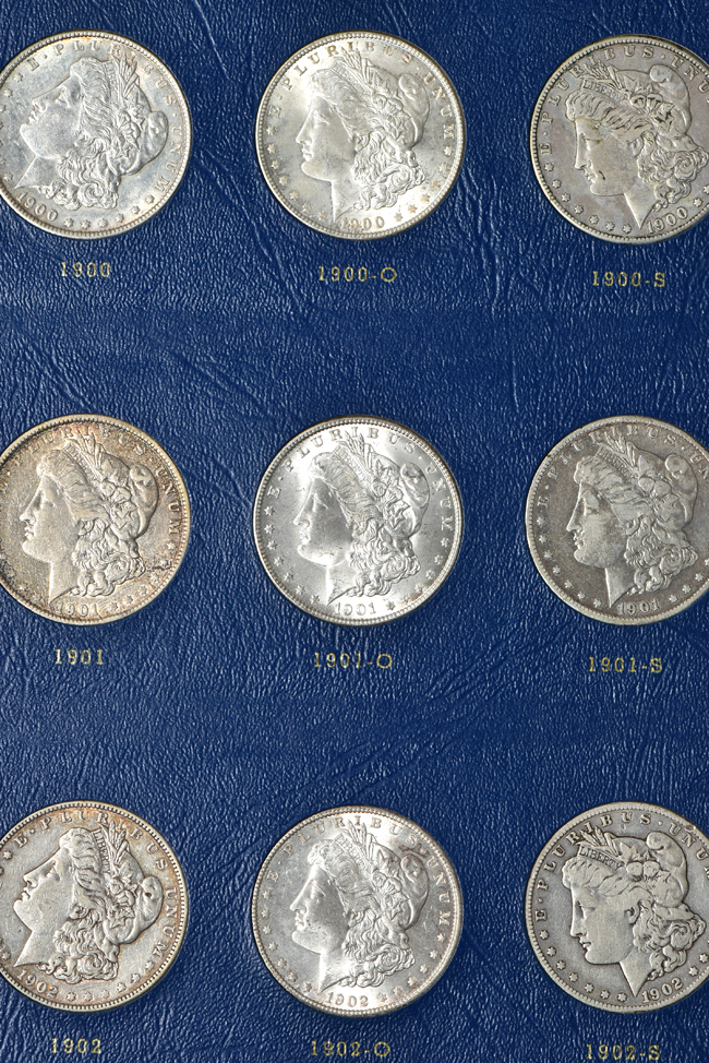 Group of fifty-seven different Morgan silver dollars in two Whitman albums