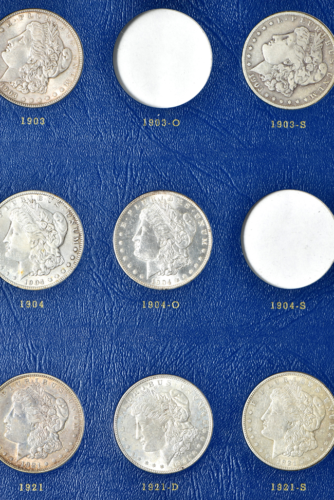 Group of fifty-seven different Morgan silver dollars in two Whitman albums