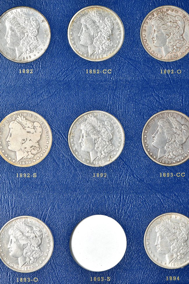 Group of thirty-three different Morgan silver dollars in a Whitman 9428 album