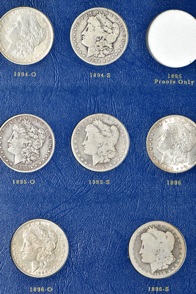 Group of thirty-three different Morgan silver dollars in a Whitman 9428 album