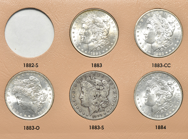 Collection of thirty-four different Morgan silver dollars in a Dansco 7178 album