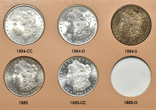Collection of thirty-four different Morgan silver dollars in a Dansco 7178 album