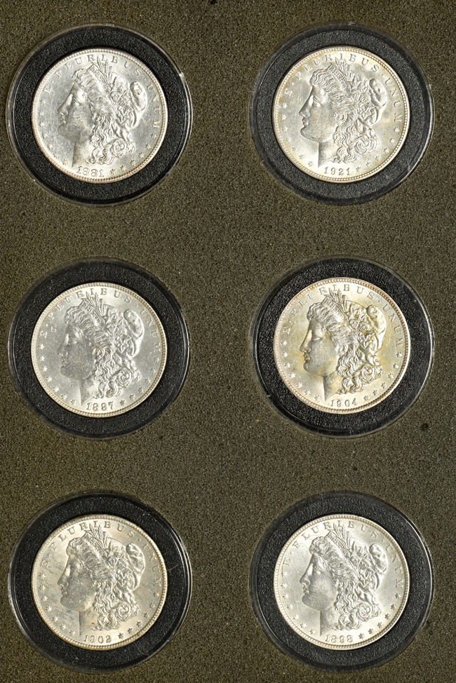 Fifteen Morgan silver dollars in a wood box