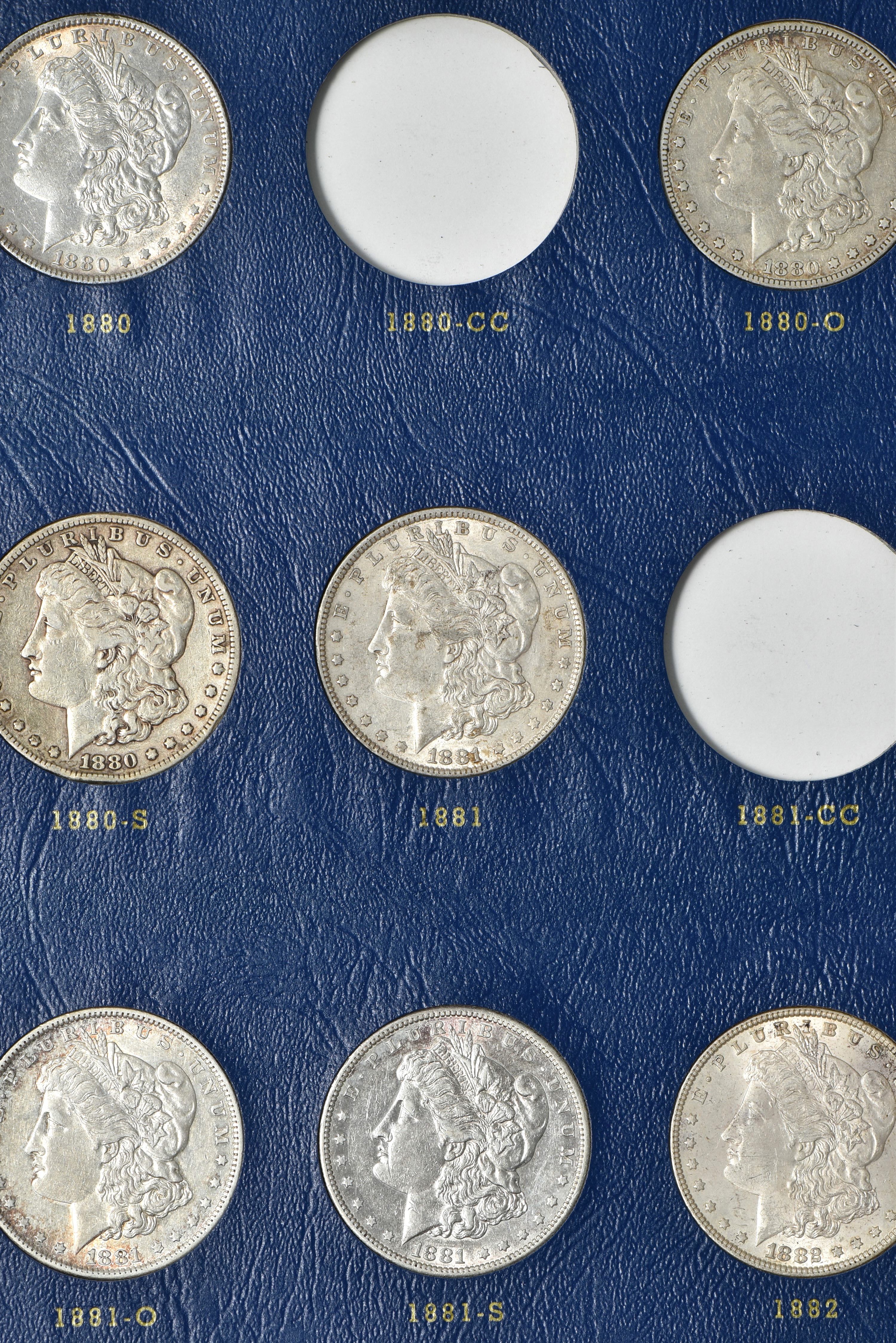 Collection of 73 different Morgan silver dollars in three Whitman albums