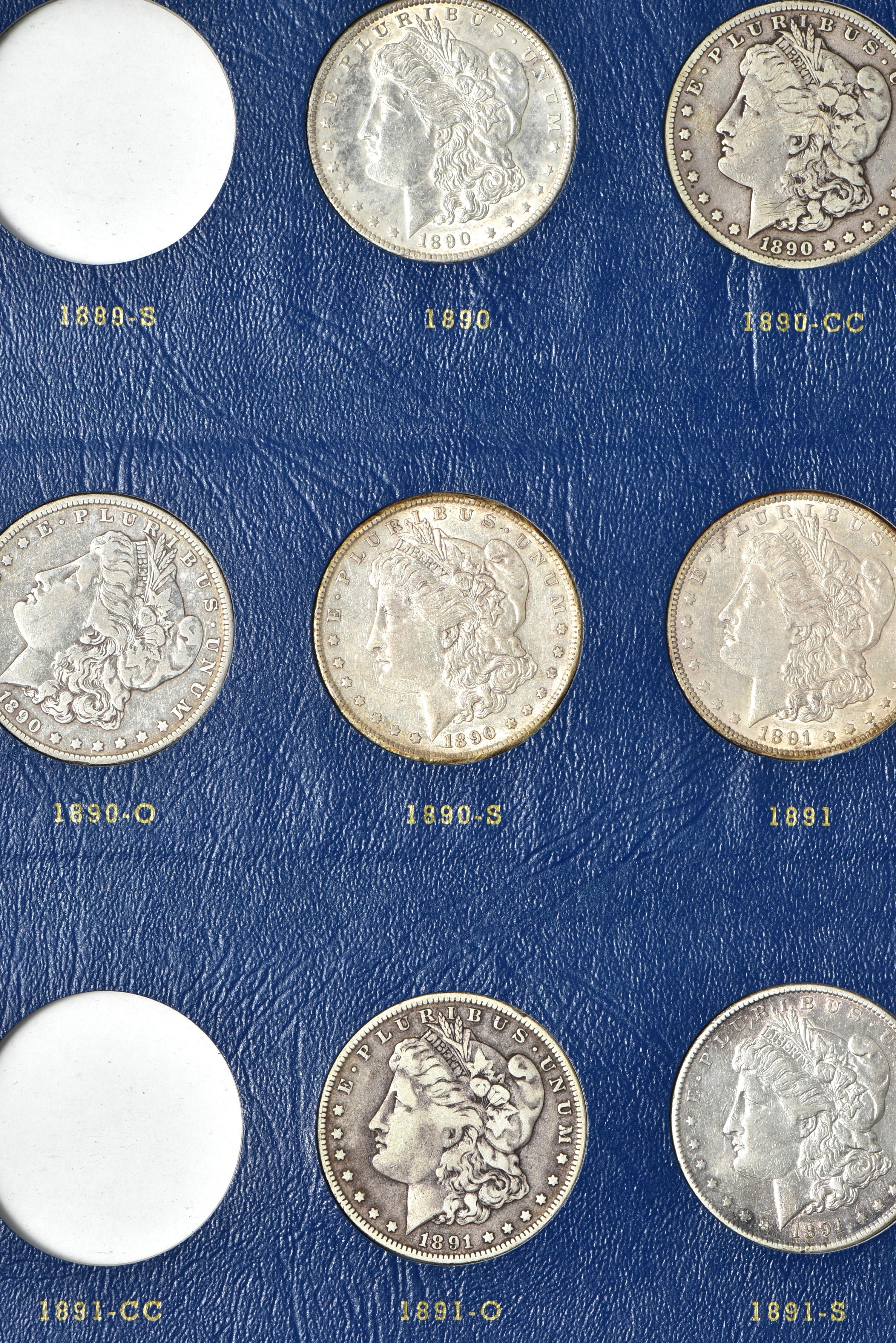 Collection of 73 different Morgan silver dollars in three Whitman albums