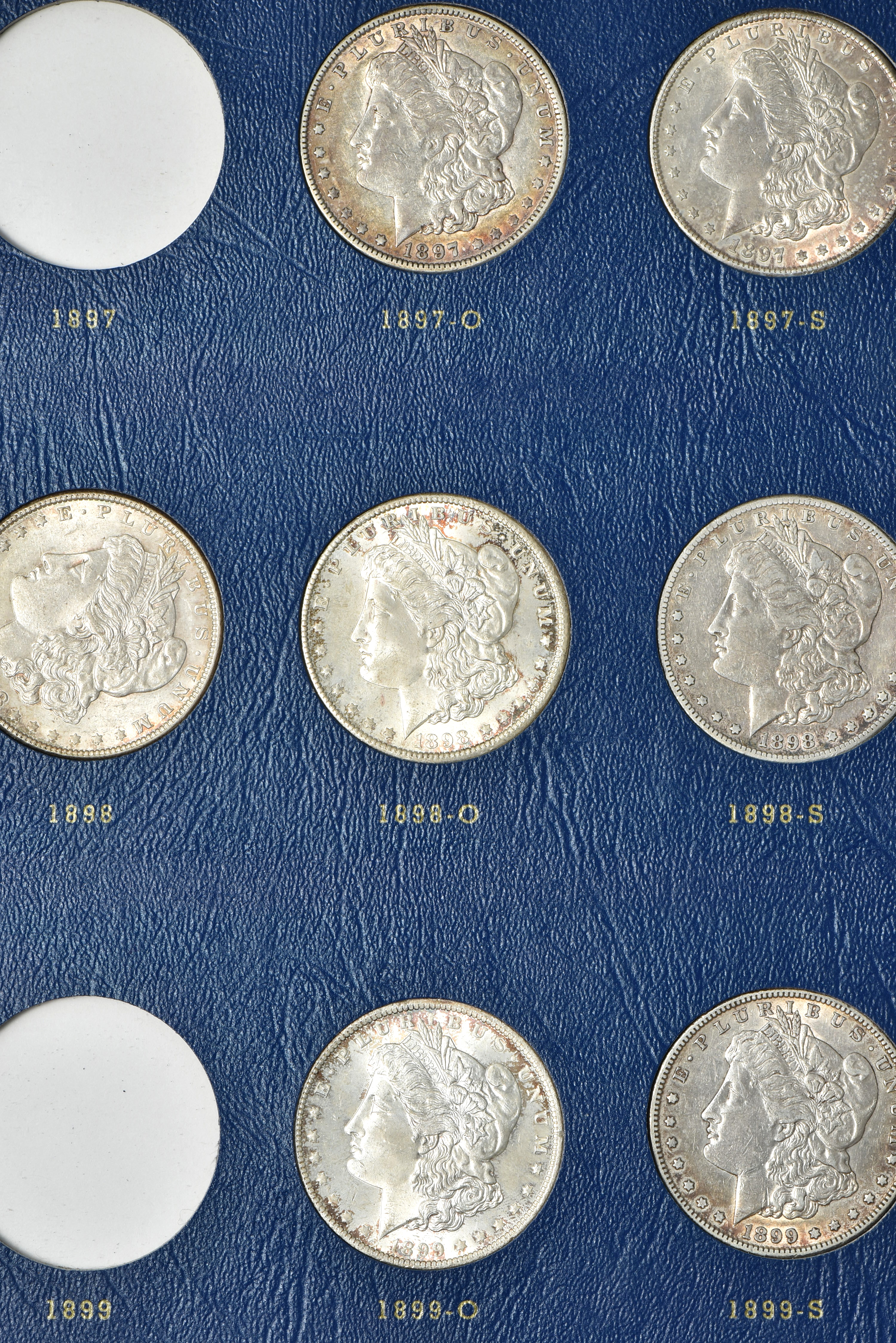 Collection of 73 different Morgan silver dollars in three Whitman albums