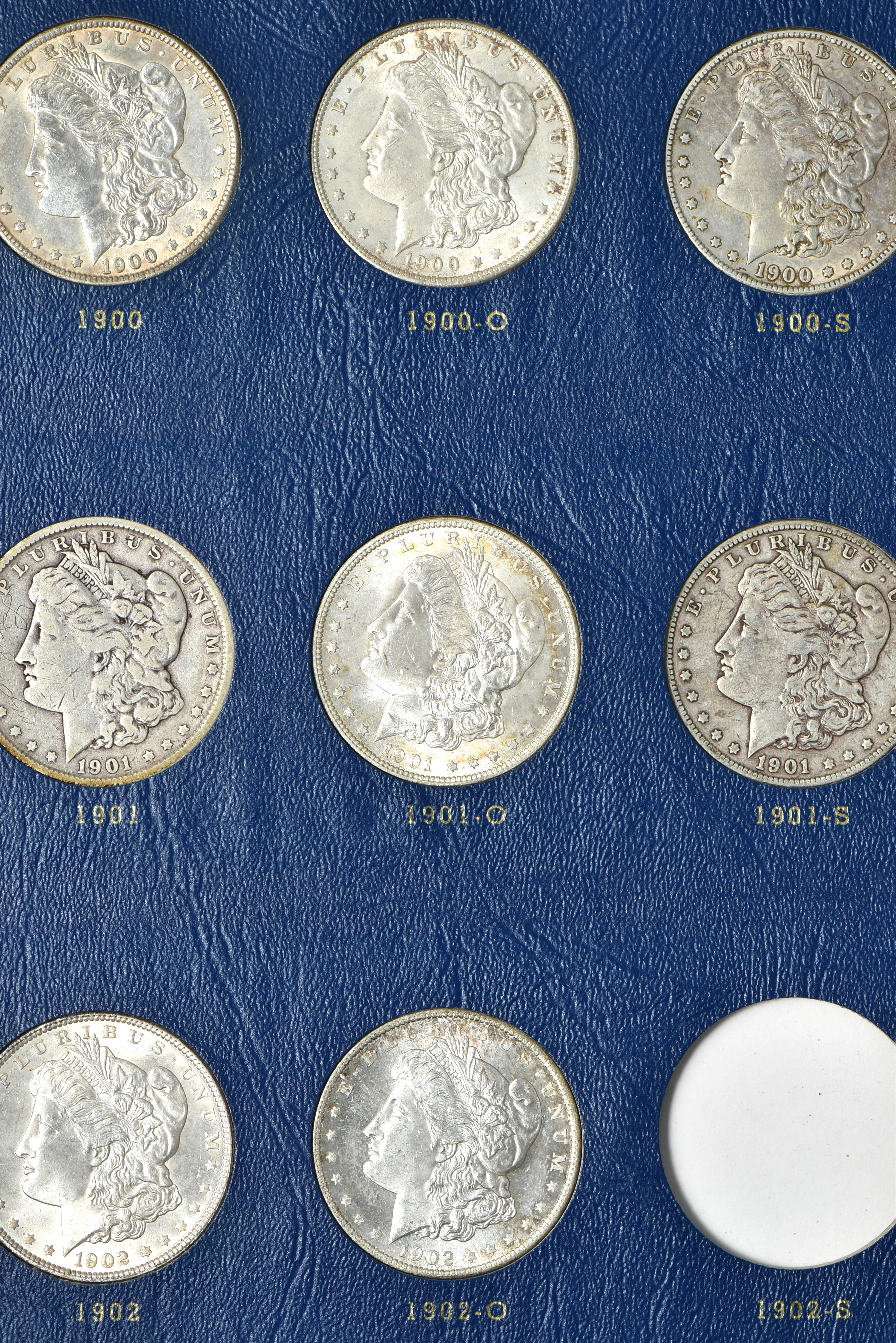 Collection of 73 different Morgan silver dollars in three Whitman albums