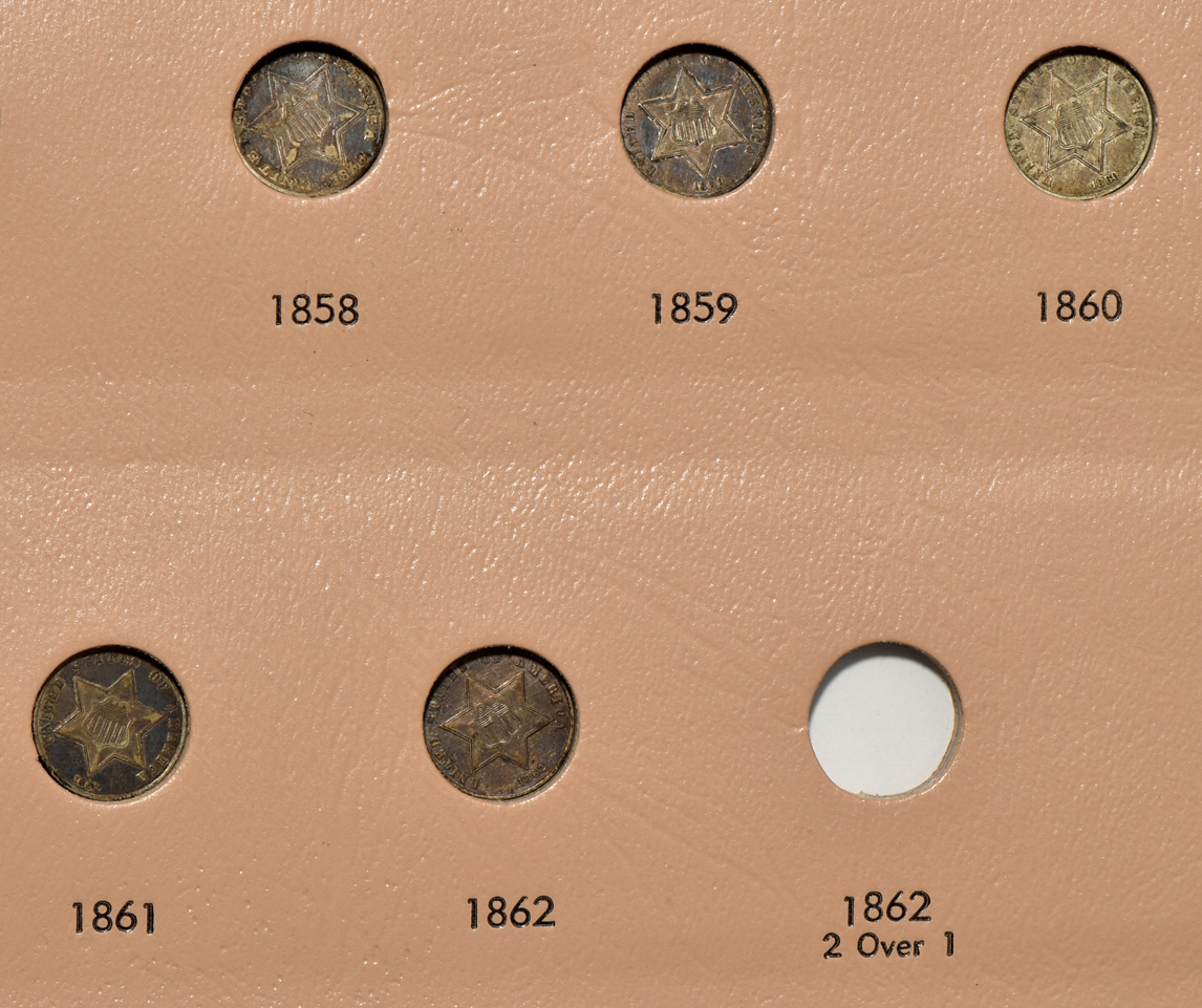 Thirteen different three-cent silver pieces in a Dansco 6109 album