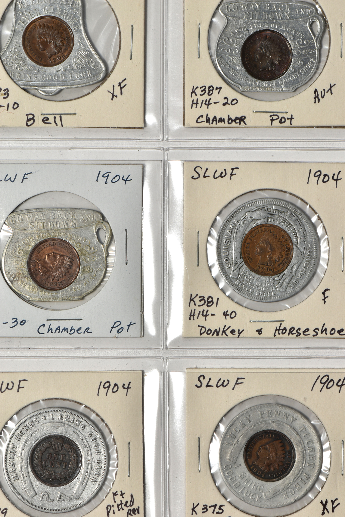 Forty 1904 World's Fair pieces in a Dansco album