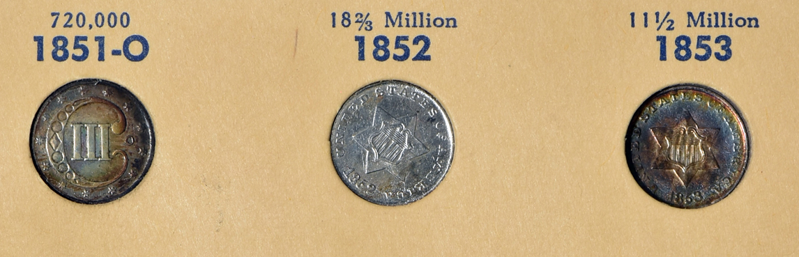 Six two-cent pieces, a twenty-cent piece, five three-cent nickels, three three-cent silvers, and eight Shield nickels in a Library of Coins Vol. 35 album
