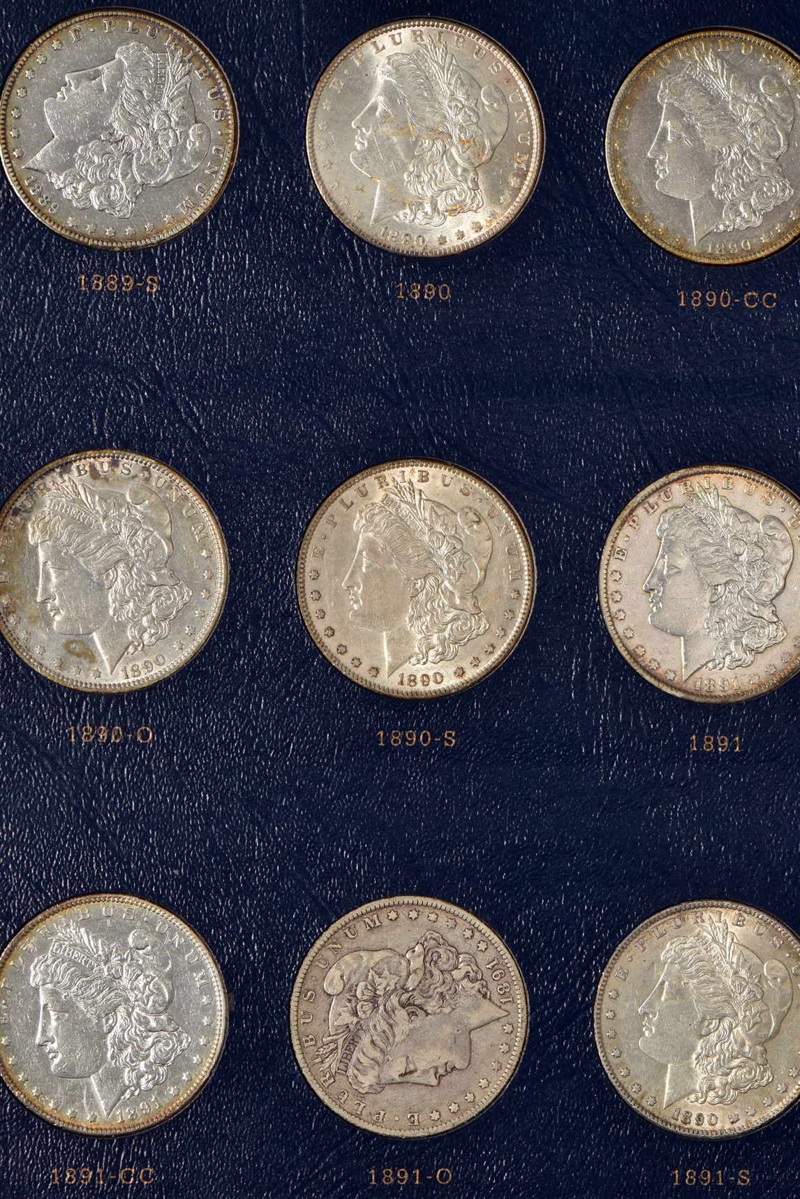 Collection of Morgan silver dollars 1878 through 1891 in a Whitman Classic 9128 album