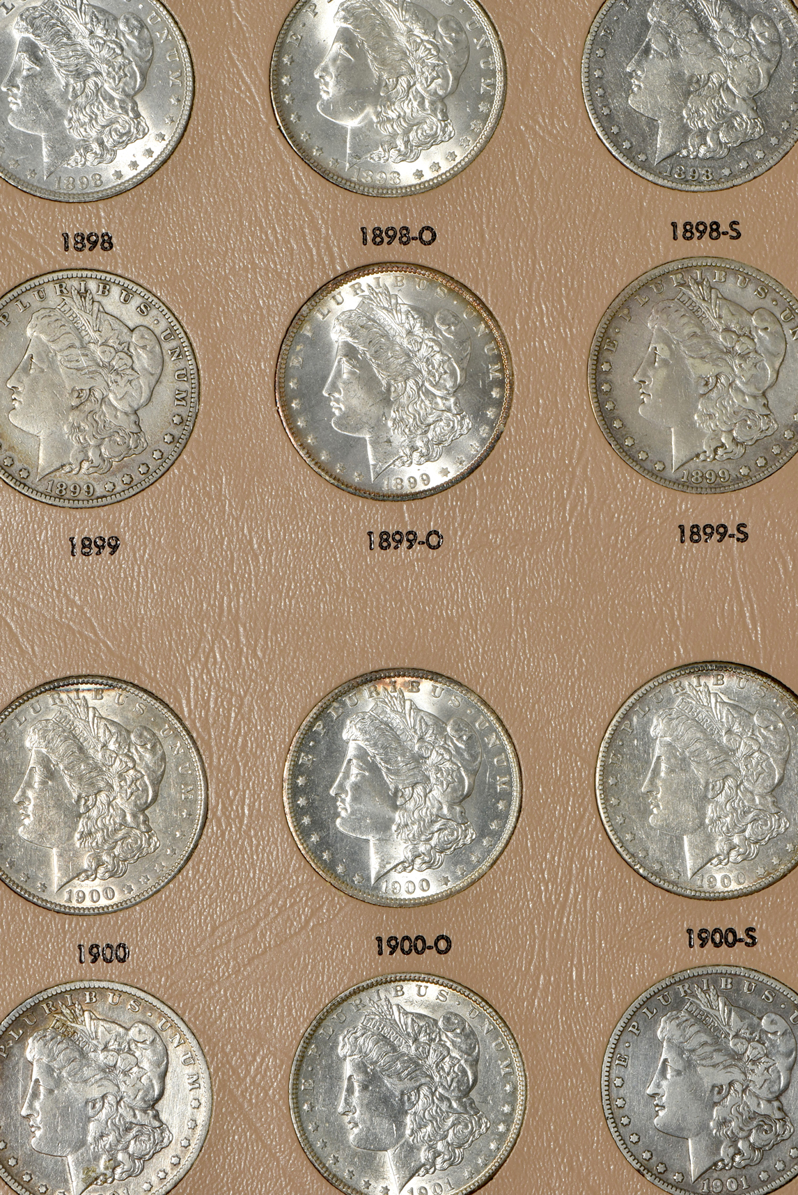 Group of 46 different Morgan silver dollars in a Dansco 7179 album