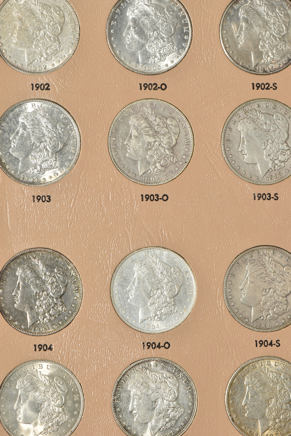Group of 46 different Morgan silver dollars in a Dansco 7179 album