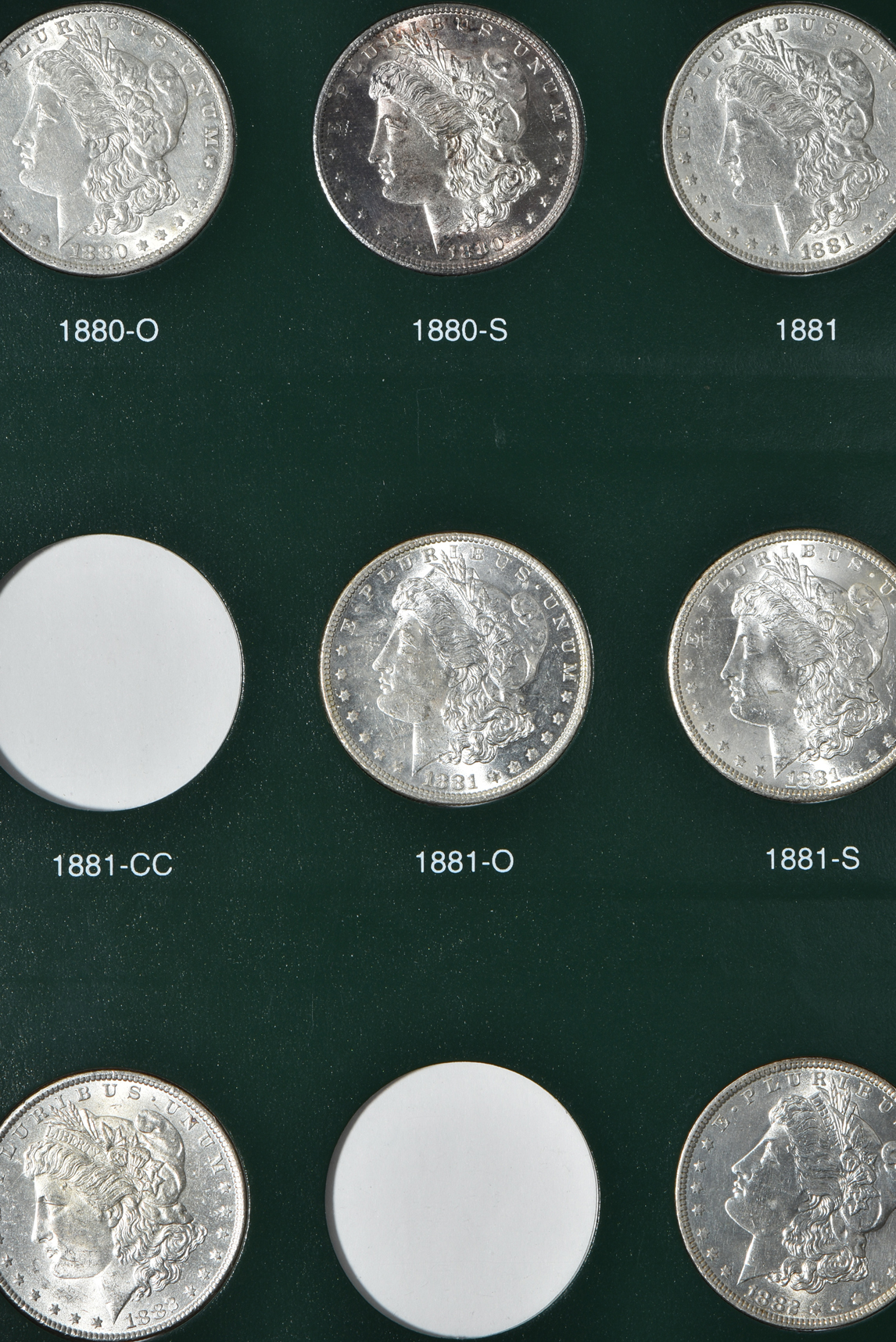 Partial collection of Morgan silver dollars in two Intercept Shield albums