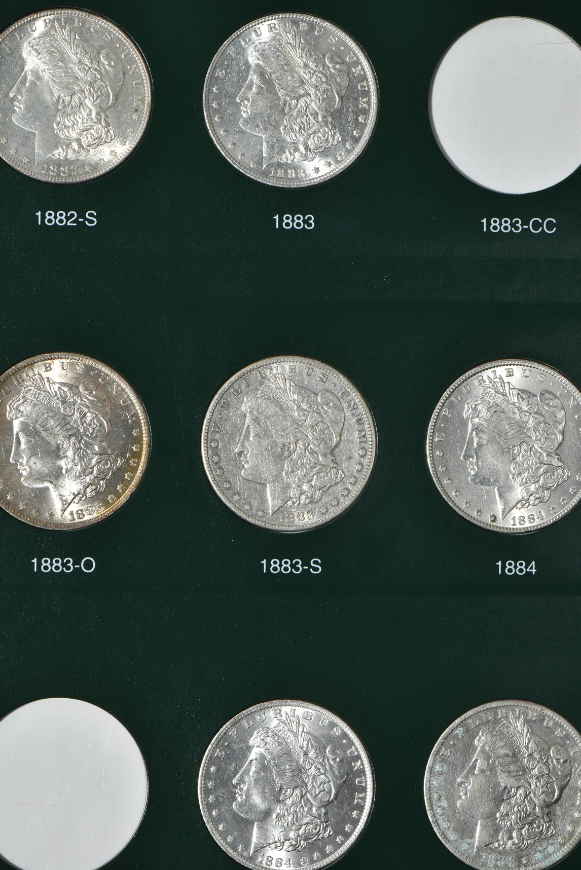 Partial collection of Morgan silver dollars in two Intercept Shield albums