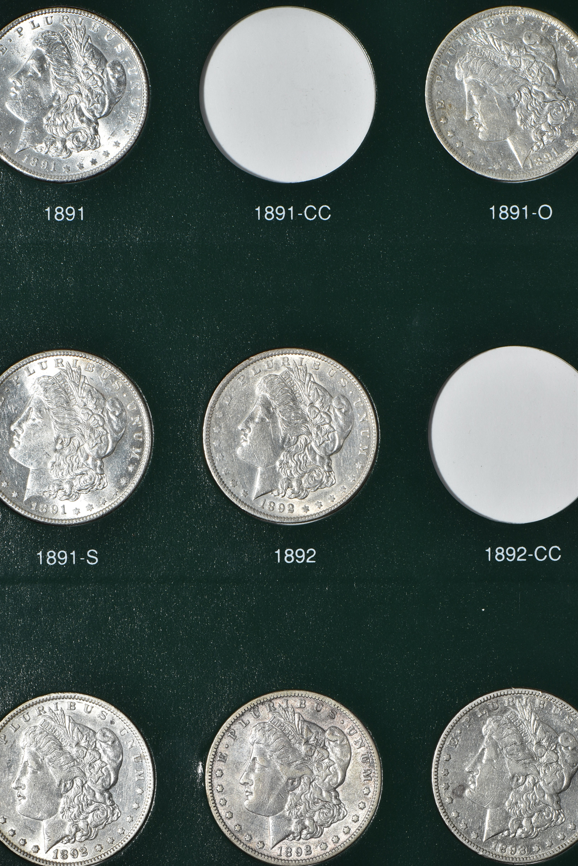 Partial collection of Morgan silver dollars in two Intercept Shield albums