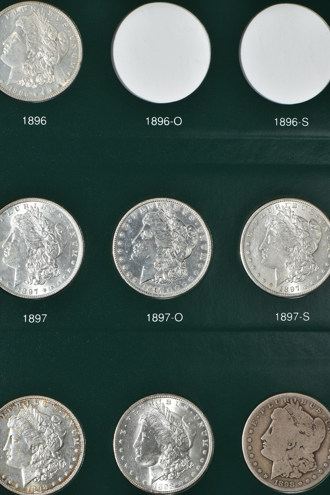 Partial collection of Morgan silver dollars in two Intercept Shield albums