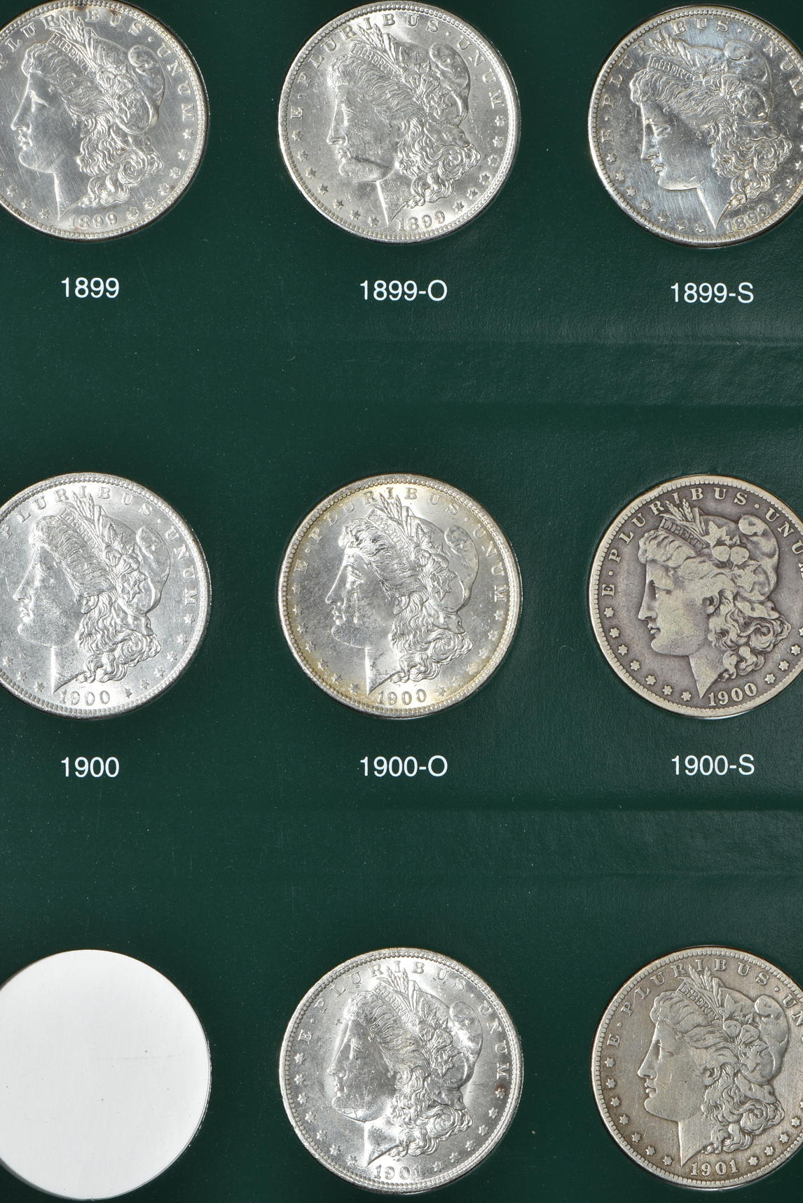 Partial collection of Morgan silver dollars in two Intercept Shield albums