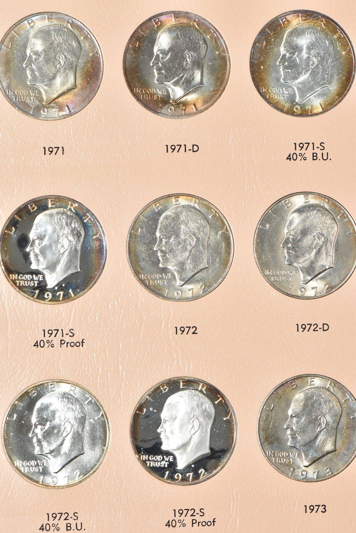 Collections of Kennedy half dollars and Eisenhower dollars in albums