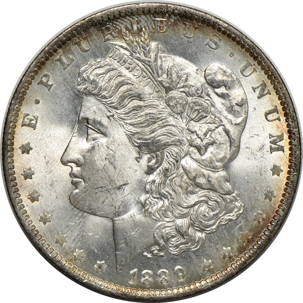 Four Morgan silver dollars, as described