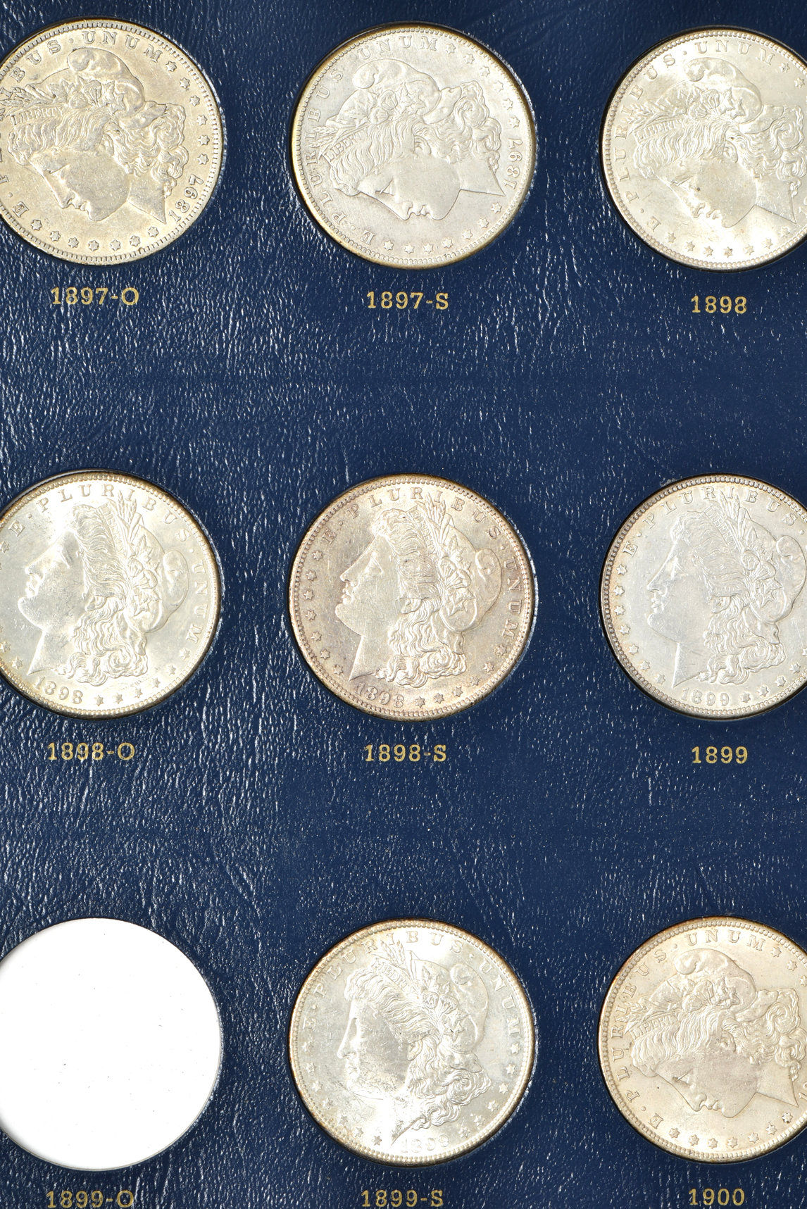 Collection of 33 different Morgan silver dollars in a Whitman 9129 album