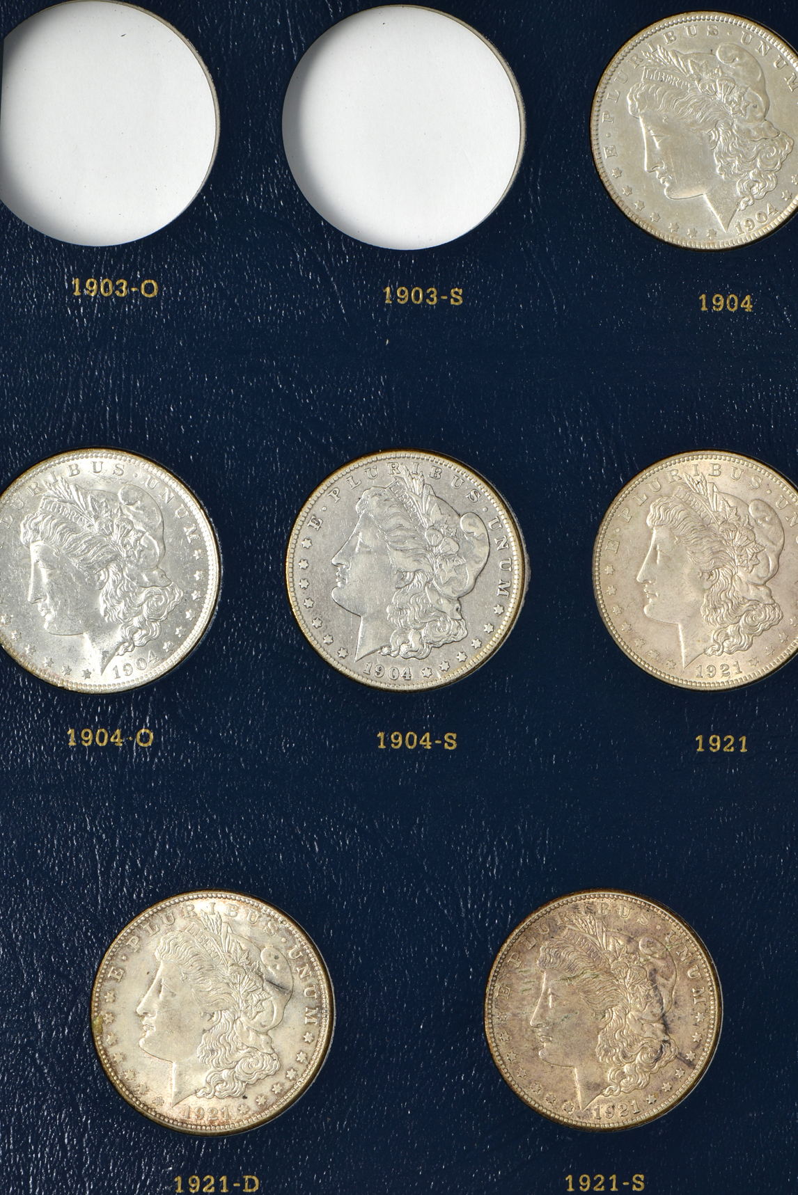Collection of 33 different Morgan silver dollars in a Whitman 9129 album