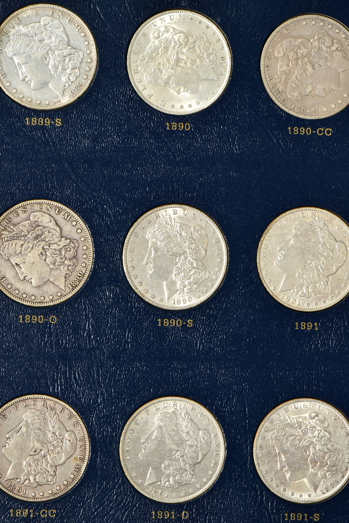 Collection of 46 different Morgan silver dollars in a Whitman 9128 album