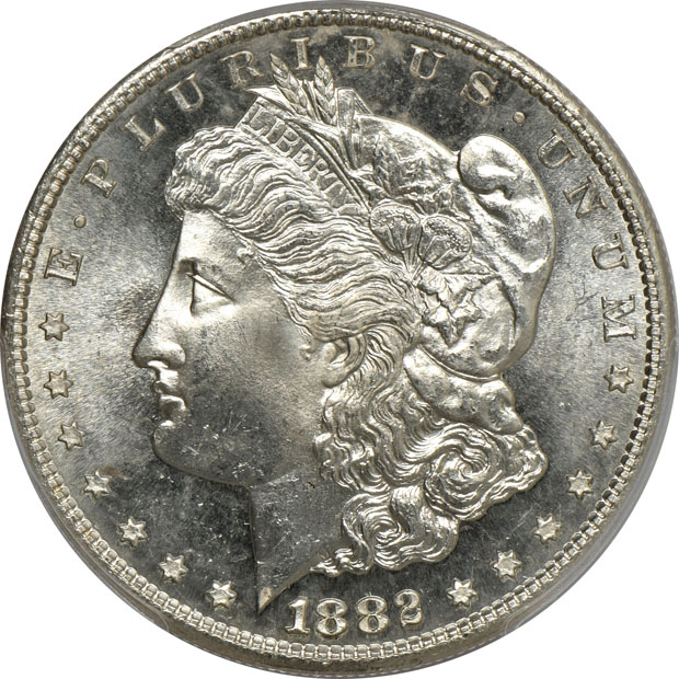 Four Morgan silver dollars.  Two PCGS MS-65, one NGC MS-65+, and one NGC MS-65
